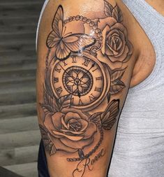 a woman with a clock and roses tattoo on her arm