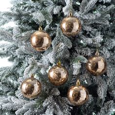 a christmas tree with gold ornaments hanging from it's branches