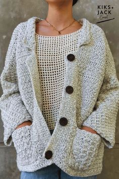 a woman wearing a sweater and jacket with buttons