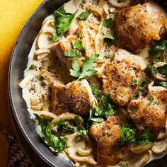 a skillet filled with chicken and noodles