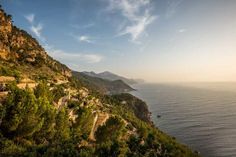 a scenic view of the ocean and mountains