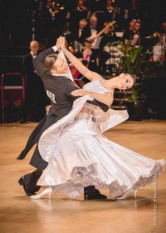 a man and woman dancing on a dance floor