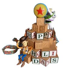 a toy story figurine sitting on top of blocks with the words happy holidays