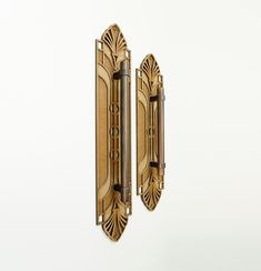 an ornate wooden door handle on a white wall