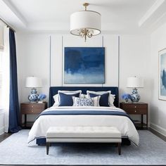 a bedroom with white walls and blue accents