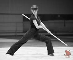 a woman in black and white holding a baseball bat