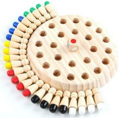 a wooden peg board with colored markers on it