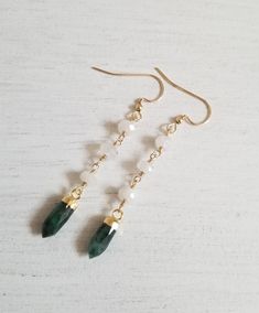 Natural Emerald spikes are paired with natural Moonstones creating this exquisite pair of earrings. Each Moonstone is hand wire wrapped with Gold Filled wire. Ear wires are Gold Filled (not plated) Giving off a bohemian vibe, these earrings are perfect for everyday as well as special occasions. Earrings measure approximately 2 1/4 inches long. Smaller Emerald earrings shown can be found here---> https://www.etsy.com/listing/783764055/emerald-spike-earrings-may-birthstone?ref=shop_home_active_ May Birthstone Crystal Drop Earrings, Dainty Earrings For Jewelry Making With May Birthstone, Dainty Natural Stone Drop Earrings, Wire Wrapped Dangle Earrings For May Birthstone, Elegant Wire Wrapped Earrings For May Birthstone, Natural Stones Dangle Earrings For May Birthstone, Dangle Earrings With May Birthstone Gemstone, May Birthstone Gemstone Dangle Earrings, May Birthstone Dangle Earrings With Gemstone