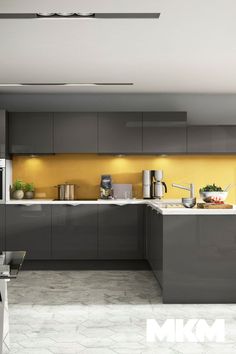 a kitchen with gray cabinets and yellow backsplash