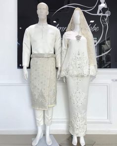 two mannequins dressed in white clothing and one wearing a veil