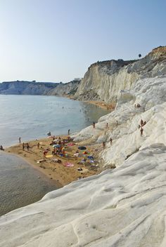 many people are on the beach and in the water