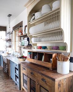 an instagram photo of a kitchen with dishes on the shelves