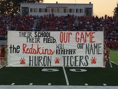 a banner on the sidelines at a football game that reads their school, their field, our game and the red lions remember