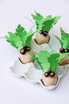 some food that is on top of a white plate with green leaves and black berries