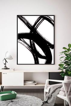 an abstract black and white painting in a living room