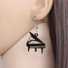 a pair of black and white piano earrings on a mannequin's head