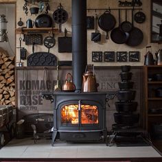 a wood burning stove sitting inside of a kitchen