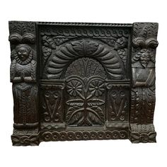 an intricately carved wooden wall panel with carvings on it's sides and faces