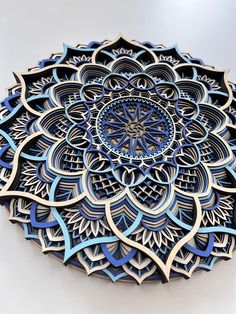 an intricate blue and white paper art piece