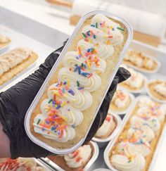 a person is holding up a tray of cupcakes