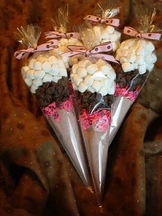 there are some white and pink candy cones in the shape of flowers on top of each other