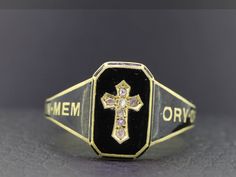 "Stunning Victorian mourning ring.  No one mourned quite like the Victorians who commissioned tokens and mementos to remember their closest loved ones.  This ring has been beautifully crafted in 18 carat yellow Gold.  Set into this ring are seven old rose cut Diamonds, sparkling out from within a yellow Gold carved cross.  The ring has been enamelled in black with the Gold lettering on the shoulder \"in memory of\" and is inscribed with the Date 1886. The condition of this beautiful Victorian mo Antique Yellow Gold Rings For Commemoration, Heirloom Engraved Ring For Commemoration With Hallmarks, Antique Ring Stamped 14k For Commemoration, Heirloom Ring Jewelry For Memorial, Heirloom Oval Ring For Commemoration, Black Enamel Ring For Anniversary, Engraved Enamel Anniversary Ring, Victorian Enamel Ring Engraved For Anniversary, Victorian Engraved Rings For Memorial