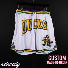 Mighty Ducks Goldberg Disney Retro Mesh Shorts Throwback Style Sports Shorts, White Athletic Shorts For Basketball Season, Collegiate White Bottoms For Sports Events, White Shorts For Basketball, White Team Spirit Athletic Shorts For Sports, White Athletic Shorts For Sports With Team Spirit, White Cotton Cheerleading Bottoms, White Shorts For Cheerleading, Casual White Athletic Shorts For Cheerleading