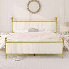 a white bed sitting in a bedroom next to a dresser and mirror on the wall