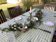 the table is set with plates and place settings