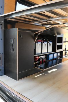 the back end of a truck with its doors open and some electrical equipment in it