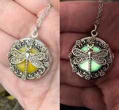 This enchanting locket possesses a secret that comes alive as the night approaches - it glows in the dark. A delicate silver dragonfly spreads its wings on top of a yellow orange background that glows a bright green in the dark. The bezel it sits on has a floral detail that brings out the nature theme of this piece.  It hangs from an adjustable silver toned chain, and can be worn from 18 inches to 20 inches.  The locket (about 1 inch in diameter) opens up to stash your special photos/treasures inside. The dragonfly itself is a symbol of transformation, freedom, and strength, making this locket an emblem of boundless possibilities. This makes an excellent gift for a loved one or yourself!  As darkness cloaks the world, the locket's glow whispers of a hidden world awaiting discovery. The sec Yellow Locket Jewelry As Gift, Yellow Locket Jewelry For Gift, Mystical Luminous Jewelry Gift, Mystical Luminous Jewelry For Gifts, Luminous Spiritual Jewelry For Gifts, Luminous Spiritual Jewelry As A Gift, Spiritual Luminous Jewelry As Gift, Luminous Pendant Jewelry Gift, Luminous Pendant Jewelry For Gifts