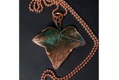 Original, unique and exclusive handmade beautiful copper jewelry pendant ivy leaf with a turquoise patina for a gift to a woman , Jewelry necklace in size 56/57 mm Hand Cast Copper Pendant Necklace, Hand Cast Copper Pendant Necklaces, Handmade Bronze Leaf Jewelry, Bronze Patina Necklace For Gift, Unique Copper Leaf Jewelry, Elegant Patina Necklaces As Gift, Elegant Patina Necklaces For Gifts, Patina Pendant Jewelry As Gift, Green Patina Pendant Jewelry