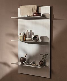 two shelves with various items on them in a room that is painted brown and white