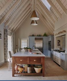 a large kitchen with an island in the middle and lots of counter space on one side