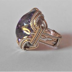 "Bold Handmade Sterling Silver Wire Wrapped Genuine Amethyst Ring Stunning Deep Purple Birthstone for February Sizing and shipping is ALWAYS FREE with a 14 day \"No Questions Asked\" return policy. lifetime warranty, free sizing and cleaning for life for life. All these are explained in the description below or feel free to reach out to us. Gemstone sizes available: S (18x13mm 3/4x1/2 inch 10+ct) This ring is made with real gems. I made it myself, so if you see a setting you like and want a diff Feb Birthstone, Wrapped Rings, Ring Wire, Jewelry Board, Purple Gift, Wire Wrapped Ring, Sterling Silver Wire Wrap, Family Jewellery, Purple Band