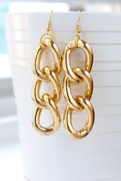 This item is completed and ready to ship! Simple, yet classic gold link chain dangle earrings. These wear very light. Each earring weighs approx 1/2 an ounce. Perfect adornment to any outfit. Makes a perfect gift for yourself or a friend. Thank-you for stopping by. Please contact me if you have any questions, or need a different quantity. Shop more earrings from my shop: https://www.etsy.com/shop/BlackBerriesBox FOLLOW: Insta: @blackberriesbox FB: BlackberriesBox **Important: Unless otherwise no Chain Link Earrings, Beaded Leaf, Gold Link Chain, Link Earrings, Gold Link, Classic Gold, Shell Earrings, Beaded Tassels, Gold Plated Chains