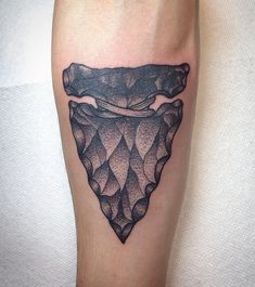 a tattoo on the leg of a man with an abstract piece of ice in it