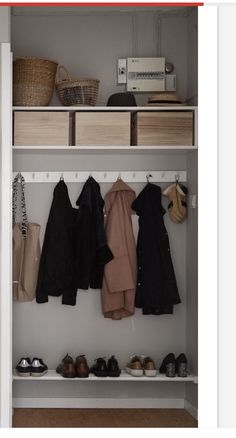 an open closet with clothes and shoes on the shelves