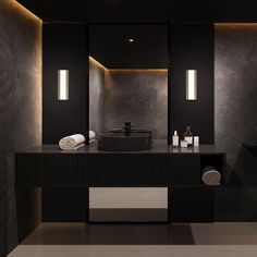 a modern bathroom with black walls and lighting