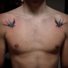 a man's chest with two small birds on the left side of his chest