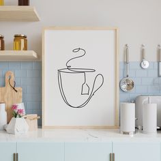 a kitchen with a coffee cup drawn on the wall next to a cutting board and utensils