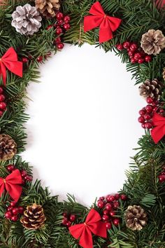 a christmas wreath with pine cones and berries