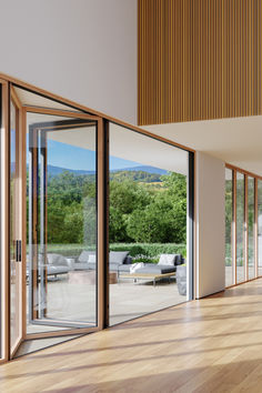 an empty room with wooden floors and sliding glass doors