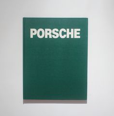 a green book with the word porsche written in white on it's cover