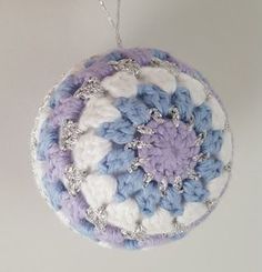 a crocheted ornament hanging from a chain