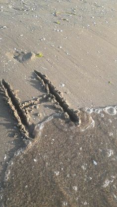 the word love is written in the sand at the beach