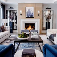 a living room with two couches and a fire place in the middle of it