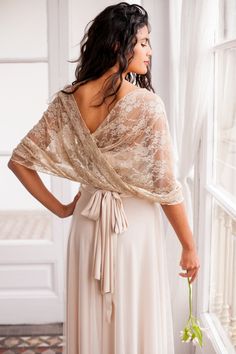 "A lace cover-up made in soft, delicate lace, perfect to match with any of our dresses for some extra coverage over the shoulders. The versatile circle design gives the shawl many possibilities, whether you want to wear it loosely over the upper arms, as a lace bolero over the shoulders or as a cape for a fuller coverage over shoulders and chest. SIZING The standard size is a onesize shawl, made to fit sizes up to EU 42/ US 12 and measures approx. 20in wide (50cm) and 57in (145cm) in circumferen Lace Winter Outfit, Wedding Dress Cover Up, Wedding Dress Shawl, Vestido Convertible, Wedding Dress Cover, Silver Cocktail Dress, Lace Shrug, Shawl Wedding, Bridal Cover Up