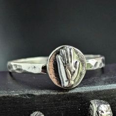 This ring is one of the first pieces I've made using my new 20 ton press.(yay  I formed the hand by melting scrap sterling silver, and pressing the silver in the die shown with my 20 ton hydraulic press. The band is half round sterling wire I rolled from melted scrap, and then hammered for texture. It's oxidized in the recessed areas, and tumbled for extra shine, as shown.  All sterling silver scrap used is 925 sterling silver, these are leftover pieces from Rio Grande Jewelry Supply, scrap wire Artisan Nickel-free Rings As A Gift, Brutalist Sterling Silver Rings As Gift, Brutalist Hammered Silver Ring, Brutalist Silver Hand Cast Rings, 20 Ton Hydraulic Press, Silver Brutalist Hand-cast Rings, Right Hand Rings, Jewelry Supplies, Rings Statement