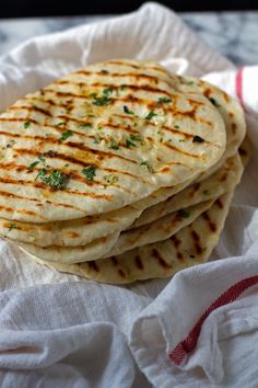 four flat breads are stacked on top of each other